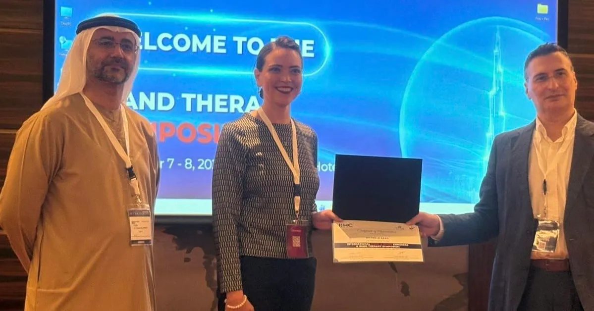 Michelle Razo at the International Hand and Wrist Congress receiving certificate