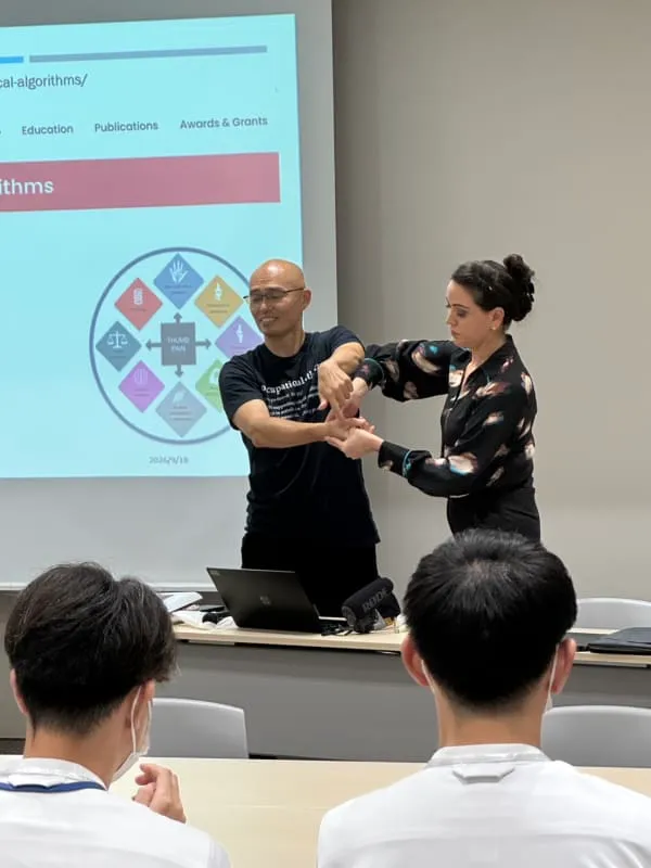 Ms Michelle Razo and Mr Hiroyasu Fujii demonstrating a manual hand therapy test at Hand Therapy Connect Event, Okayama, Japan